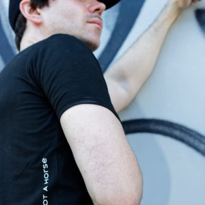 not a horse - Unisex T-Shirt model wall leaning zoomed